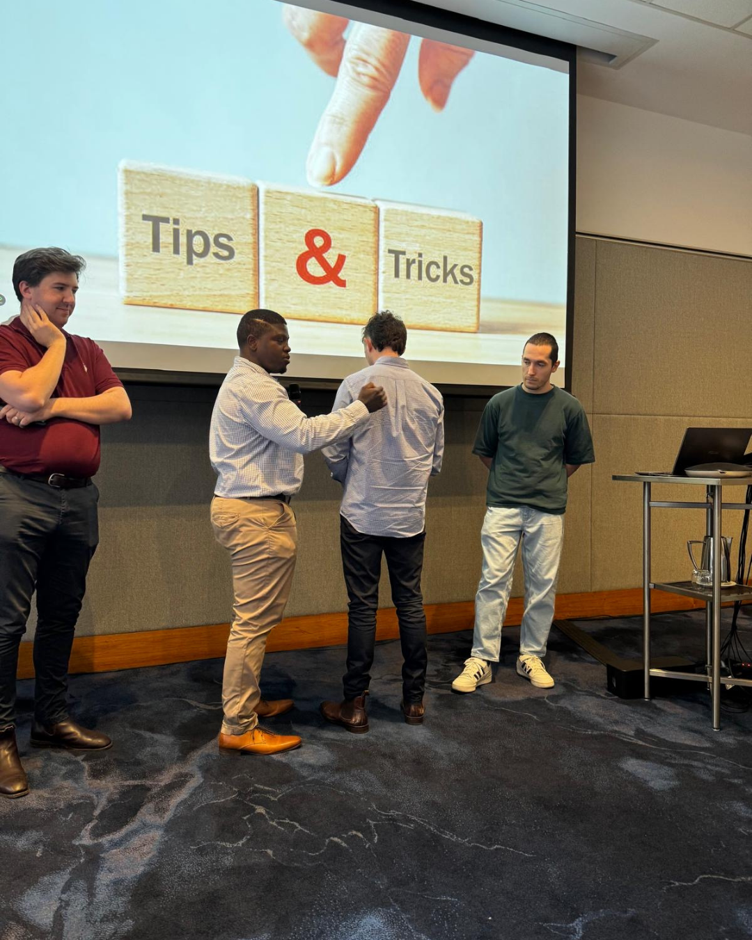 Conference presenters demonstrating practical clinical techniques during a Tips and Tricks session at the Shoulder to Hand Alliance 2025 Hand Therapy Conference.