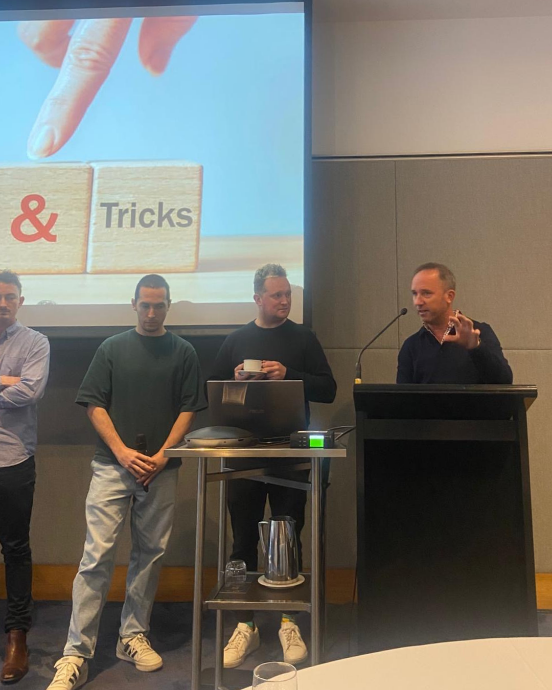 Conference presenters discussing clinical practice insights during a Tips and Tricks presentation at the Shoulder to Hand Alliance 2025 conference.