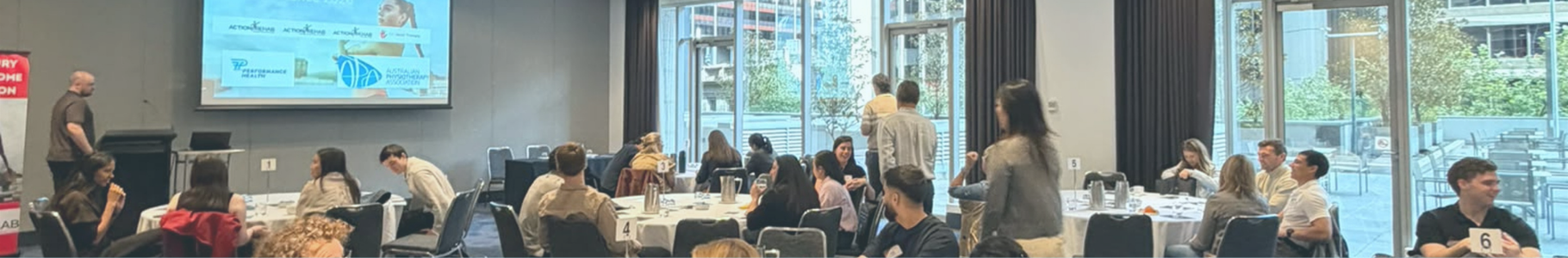 Conference delegates networking and participating in group discussions during the Shoulder to Hand Alliance 2026 Hand Therapy Conference.